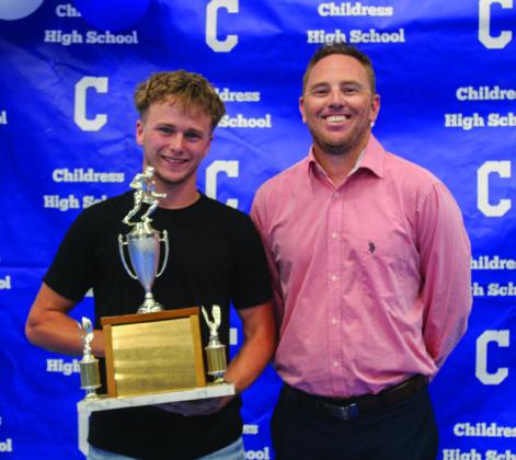 Kashton Patterson, left, accepts the Fighting Heart Award from football coach Brady Blake.