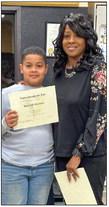 Austin Elementary School fourth-grader Braxton Maddox receives his Superintendent’s List certificate from Memphis Independent School District (ISD) Trustee Charlotte Maddox.