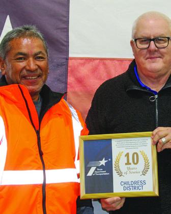 Texas Department of Transportation (TxDOT) Childress County Equipment Operator Gilberto Ramirez receives a 10year service award from TxDOT Childress District Engineer Darwin Lankford.