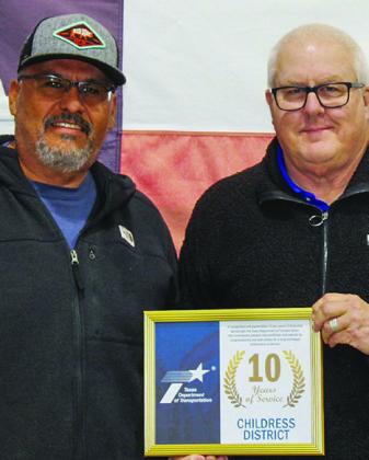 Texas Department of Transportation (TxDOT) Collingsworth County Assistant Supervisor Roy Vela Jr. receives a 10-year service award from TxDOT Childress District Engineer Darwin Lankford.