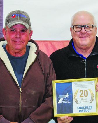 Texas Department of Transportation (TxDOT) Special Jobs Equipment Operator Phillip Gray receives a 20-year service award from TxDOT Childress District Engineer Darwin Lankford.