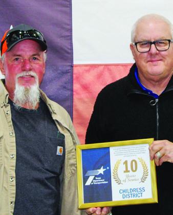 Texas Department of Transportation (TxDOT) Facilities Journeyman Electrician James Allen receives a 10-year service award from TxDOT Childress District Engineer Darwin Lankford.