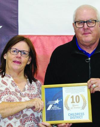 Texas Department of Transportation (TxDOT) Childress District Headquarters Contract Specialist Jeffy Garza receives a 10-year service award from TxDOT Childress District Engineer Darwin Lankford.