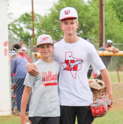 Brothers, Wellington Junior High School sixthgrade catcher Jake Anderson and Wellington High School sophomore pitcher Jax Heflin, execute the first pitch at the Opening Day festivities.
