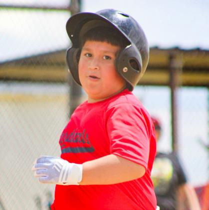 Wellington second-grader Jonathan Robles, a member of the Coach Pitch Division Cardinals team, steps up to bat in the Opening Day game on Saturday, April 10. SHAUNA SALINAS/THE RED RIVER SUN