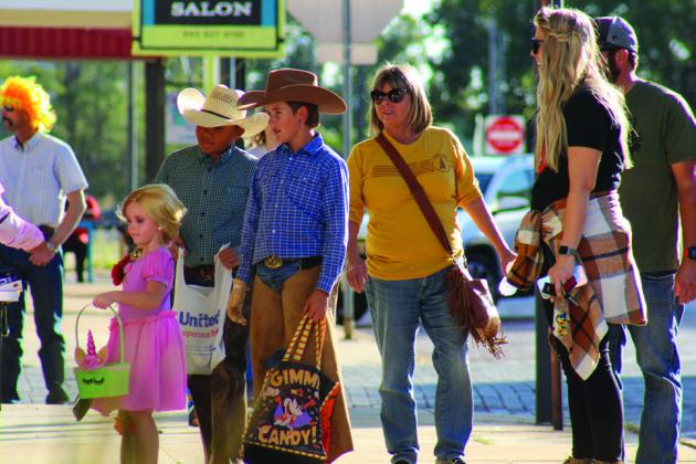 Trick-or-treaters Bryar Chapman, left, Bryson Session and Slade Chapman, accompanied by Debbie Chapman, Kelsi Chapman and Jake Chapman, attend the 2021 Childress Main Street Downtown Trick-or-Treating event. This year, the annual event will be held from 5-6 p.m. Saturday, Oct. 29 on Main St. and Commerce St. The Red River Sun/Elizabeth Tanner
