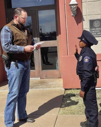 Childress County Sheriff Matthew Bradley swears in 11-year-old Devarjaye “DJ” Daniel, who is battling terminal brain and spinal cancer, Saturday, April 1. Photos Courtesy of Matthew Bradley
