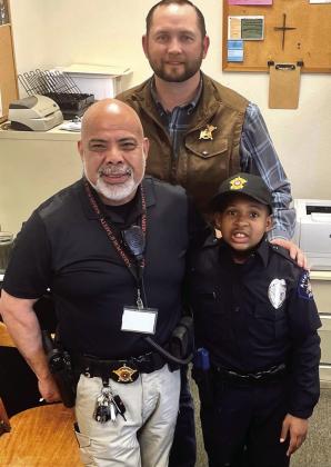 Childress County Sheriff Matthew Bradley and Childress County Chief Deputy Roy Rodriguez congratulate Devarjaye “DJ” Daniel on being sworn in as Childress County Honorary Deputy Sheriff.