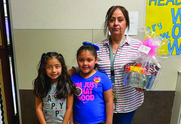 Austin Elementary School students Leila Rojas and Yaretzy Rodriquez thank custodian Dora Flores.