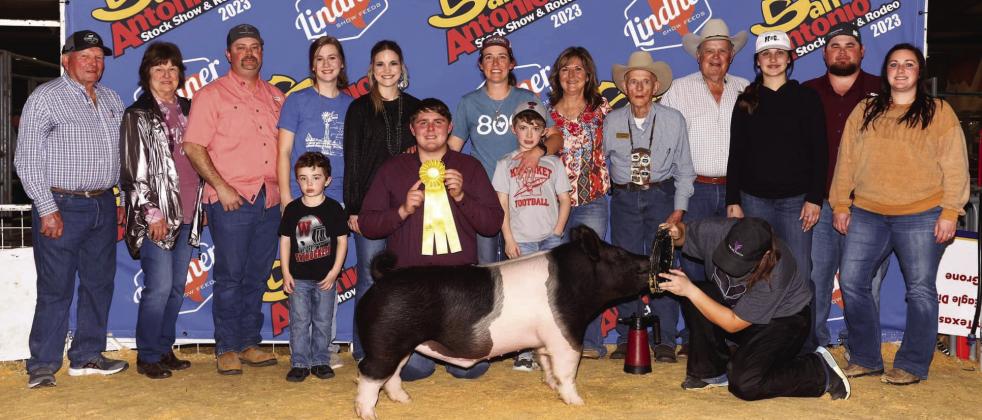 Wellington High School senior Hunter Stark earns fifth place with his heavy middle weight Hampshire and a place in the sale at the recent 2023 San Antonio Stock Show and Rodeo. Front row, from left: Maxon Orr, Stark, Maverick Orr. Back row, from left: Weldon Walser, Annette Walser, Matt Orr, Brooklyn Teeters, Kamryn Teeters, Marcie Orr, Veronica Gray, Ed LaGrone, Claud Crisp, Emma Flores, Kenny Patterson, Brooke Patterson. Courtesy Photo