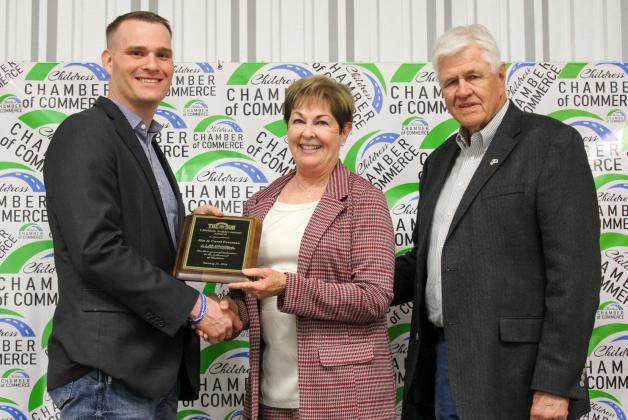 Jim and Carol Freeman receive the Lifetime Achievement Award, presented by Childress Chamber of Commerce Board of Directors member Travis Brooks, during the 2025 Childress Chamber of Commerce Banquet Awards Ceremony Monday, Feb. 16 at the Mashburn Event Center. The Red River Sun/Elizabeth Tanner