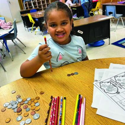Travis Elementary School teacher Kaprisha Casas’ kindergarten students learn to count money. Students were even able to use the play money to purchase pencils. Photos Courtesy of Memphis ISD