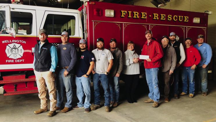 The Wellington Volunteer Fire Department accepts a $15,000 donation from The 100 Club of the Texas Panhandle Tuesday, April 9. From left: Korn Wiebe, Wes Williams, Ethan Cummings, Benny Wiebe, Henry Wiebe, The 100 Club of the Texas Panhandle Executive Director Suzanne Talley, Wellington Fire Chief Sawyer Sims, Dispatcher Dave Griminger, Colby Henard, Matt Orr, Hunter Stark. The Red River Sun/Bev Odom