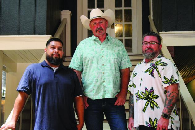 Former “Rocky Mountain Bounty Hunters” star Dayson Goetz, alongside manager Roy Rodriguez, left, and saloon manager Michael Burrows, opens the doors to Porky’s Smokehouse and Saloon.