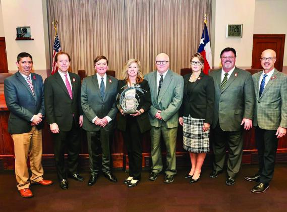 Texas Department of Transportation Childress District Traffic Safety Specialist Nicole Tyler, center, is presented with the GRIT Award by the Texas Transportation Commission Tuesday, Dec. 13 in Austin. Courtesy Photo