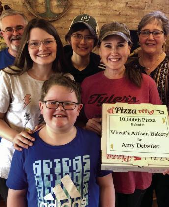 Amy Detwiler, along with family, recently purchases the 10,000th pizza made a Wheat’s Artisan Bakery. Wheat’s Artisan Bakery, 424 Commerce St., is open 11 a.m.-7 p.m. Wednesday-Saturday. Photo Courtesy of Wheat’s Bakery