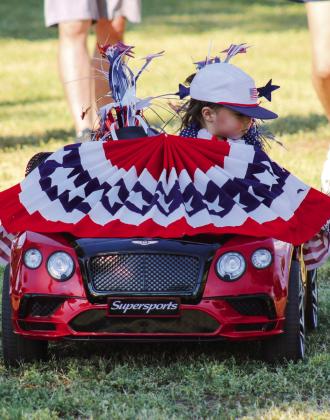 Volan Vest, one-year-old son of Vandon and Soni Vest, competes in the Fourth of July Party in the Park Kids Parade.