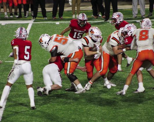 Wellington’s Caleb Strickland (8) tackles a Petrolia offensive lineman with help from Miguel Rincon (5), Anthony Ortiz (15), Hunter Hedrick (52) and Jovani Munn (67) Thursday, Nov. 14 during the Skyrocket’s 36-0 sweep.