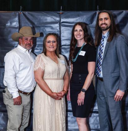 Edward Jones Financial Advisor Keyan Keys, of Childress, accepts the Frank Finnegan Award, an award which recognizes exception achievement in building client relationships. From left: Cody Favor; Childress Branch Office Administrator Nikki Favor; Keys; and Keys’ wife, Kelli Keys.