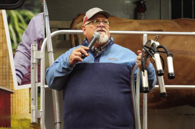 Southwest Dairy Farmers Mobile Dairy Classroom Instructor Todd Griffin, along with four-year-old Jersey milk cow Buttercup, gives a milking demonstration during Childress County Ag Day.