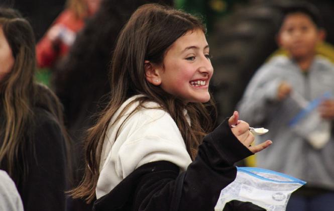 Childress Elementary School fifth-grader Jaidee Cribbs enjoys hand-shaken, homemade ice-cream-in-abag during the 2023 Childress County Ag Day event Wednesday, Nov. 1. The Red River Sun/Kaeley Rothwell