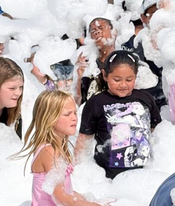 Summer readers frolic in library’s foam party