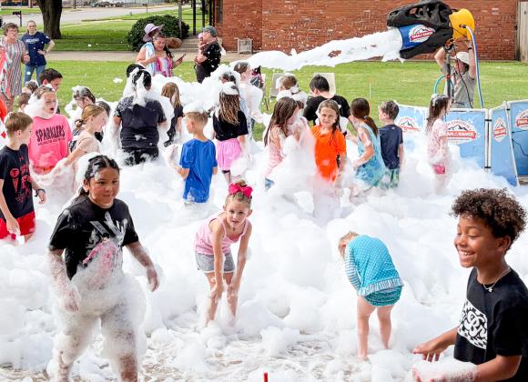 Summer readers frolic in library’s foam party