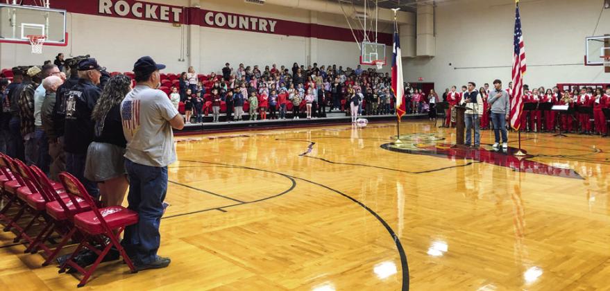 Wellington High School (WHS) Student Council President Noah Cantu, left, assisted by Vice President Dixon Dugan, leads the Pledge of Allegiance.