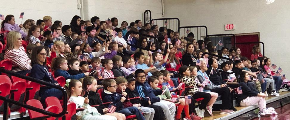 Wellington Elementary School second- through fifthgrader students wave their flags during performances.