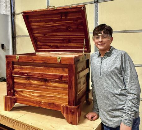 Second-year woodworking student Hutch Ollinger shows off his recently completed project, a cedar chest. According to Memphis Independent School District (ISD) woodworking instructor Ramiro Salaz, Ollinger has mastered many tools, techniques and skills necessary to create and build fine furniture.