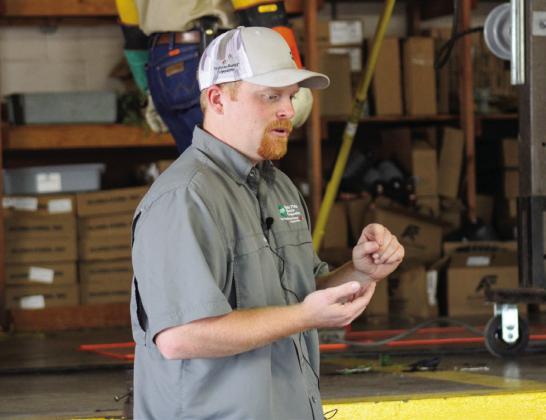 Member Service Representative Supervisor Jim Lile explains how conductors work during an arcing demonstration.