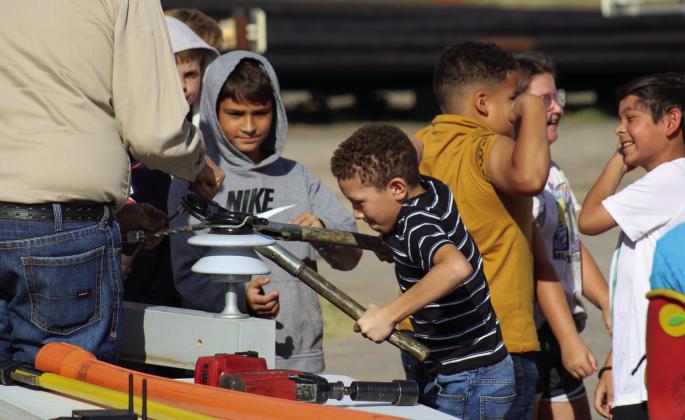 Students learn to use lineman tools.