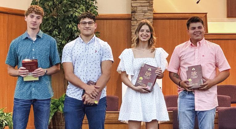 Members of the Wellington High School Class of 2024 receive recognition Sunday, May 5 during the morning worship service at First Baptist Church. Each student received a bible, presented by Kelli Killian. From left: Nixon Folk, Ethan Nevarez, Summer Neufeld, Tryston O’Rear. Courtesy Photo