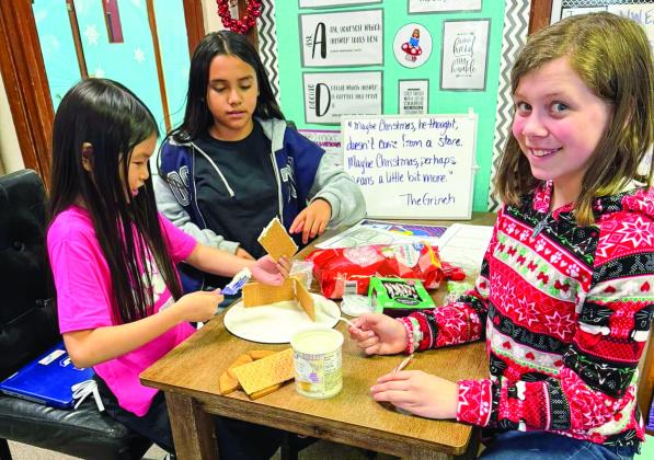 After researching and designing gingerbread houses, Childress Elementary School fifth graders bring their ideas to life prior to the holiday break. Photos Courtesy of Childress Elementary School
