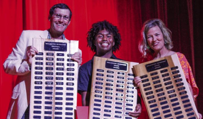 Wellington High School senior Travon Lewis earns the Football Outstanding Back Award, Boys’ Track Sprinter Award and the Tennis Frank Campbell Award, presented by Athletic Director Greg Proffitt and Coach Amy Inman.