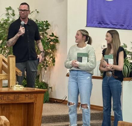 First Christian Church celebrates Senior Sunday on Sunday, May 11, as Pastor Will Grant congratulates Wellington High School (WHS) senior Gracie Lampe and West Plains High School senior Madison Higgins with special study Bibles. WHS junior Kenady Skelton led the worship service.