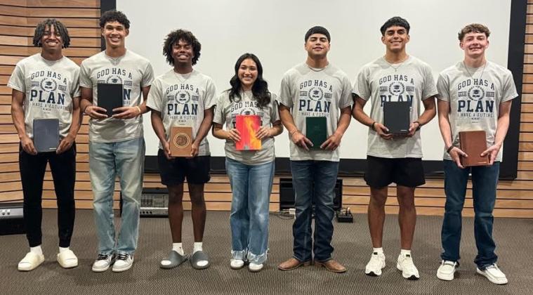 Trinity Fellowship observes Senior Sunday, presenting Wellington High School seniors with a personalized Bible during its Sunday evening, May 4 service. From left: DeMarcus Lewis, Brenden Garcia, Travon Lewis, Christell Melendez, Miguel Rincon, Anthony Ortiz, Carvin Wischkaemper.