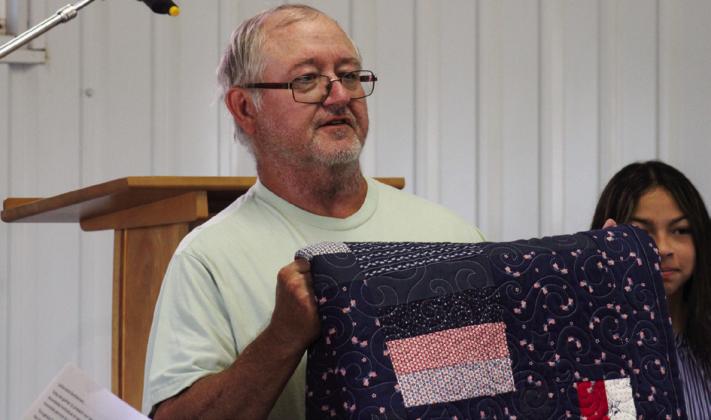 Veteran James Gray, U.S. Army Sergeant First Class, receives the second-ever Childress County 4-H Quilt of Valor at the Childress Elks Lodge #1113 Memorial Day Service Monday, May 26 at Jones Chapel in Childress Cemetery. The Red River Sun/Elizabeth Tanner
