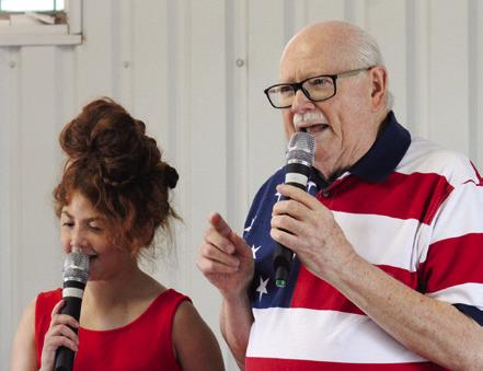 Monson Music Studio’s Bella Blu Sanders and Gerald Monson perform “God Bless America,” asking the audience to join in, at the Childress Elks Lodge #1113 Memorial Day Service Monday, May 26 at Jones Chapel in Childress Cemetery.