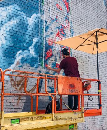 The same artist who painted the murals in Clarendon and Claude, Malcom Byers paint medium is spray paint. While the Wellington mural is one of his most developed designs, it took a very long time to produce. The Red River Sun/Bev Odom