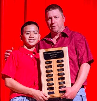 Wellington High School Junior Dahmian Salinas accepts the Baseball Most Valuable Player Award, presented by Coach Jeff Anderson.