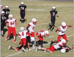 Eighth-grade Firecracker Conner Bowen (11) attempts to recover a fumble during Wellington’s 44-6 win over Memphis. While the Whirlwinds ultimately recovered their ball, Wellington players flew to the scene, including Kingston Molina (60), Jacob Garcia (32), Troy Molina (6), Dahmian Salinas (4), Hunter Hedrick (54) and Sebastian Pina (53). The Red River Sun/Shauna Salinas