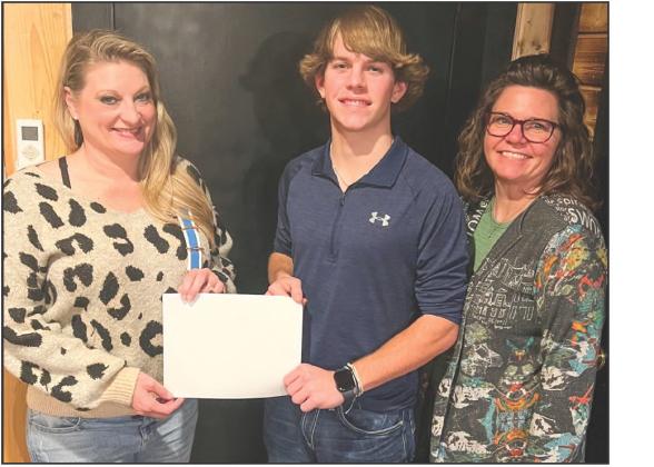 Regent Czrena Watts, left, awards the DAR Good Citizen Certificate to Caleb Weinette. The son of Brandi and Gene Weinette, his mom witnessed the presentation.