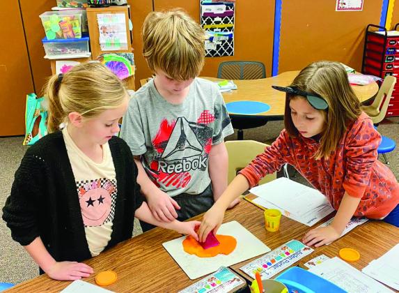 Childress Elementary School students explore two dimensional and three dimensional shapes, using Play-Doh to create impressions and count shapes’ faces, in Townly Thomas’ class. Photos Courtesy of Childress Elementary School
