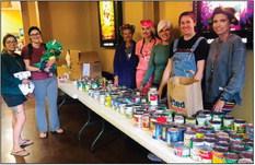 Upon entry to the Ritz Theatre’s Halloween Spectacular Monday, Oct. 23, Jessica Hall, daughter Nicole Holland and grandson Cove Stephens offer canned food for admission to the event. Ritz Board of Directors Amy Inman, Tracy Ouellette, Lyndy Forrester-Black, Tanna Roberson and Lesa Thornberry accept the donations to restock a local food pantry. The Red River Sun/Bev Odom