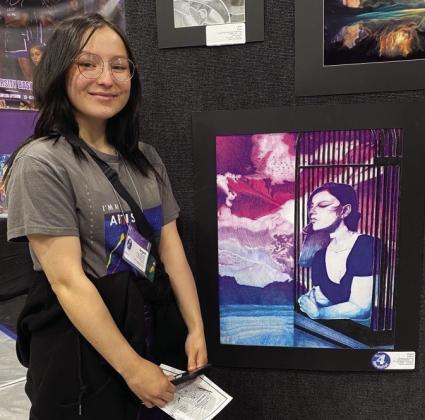 Angela Molina displays her winning piece, “The Purpose of the Crow.”