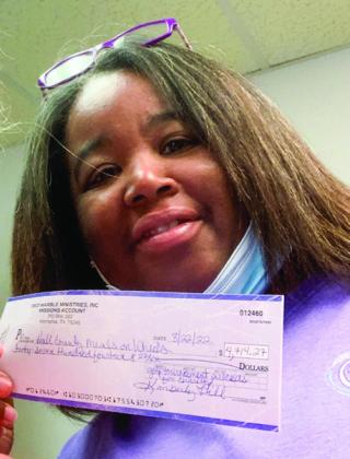 Memphis Meals on Wheels Director Taniya Johnson accepts a donation totaling $4,714.27, which was raised during the Red Marble Ministries 2022 Golf Tournament.