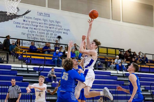 Childress defenders, including Kaleb Mayden, Billy Moore and Aiden Allen, attempt to block Canyon’s Kelson Jones during the Tatum Tough Tournament championship game Saturday, Dec. 30 in Canyon.