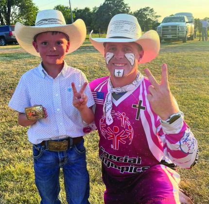 Two-time Mutton Bustin’ champion Caleb Peters accepts congratulations from Goobie the Clown during the 20th Annual Wellington Fourth of July Rodeo. Peters is the son of Ben and JoAnna Peters. Courtesy Photo