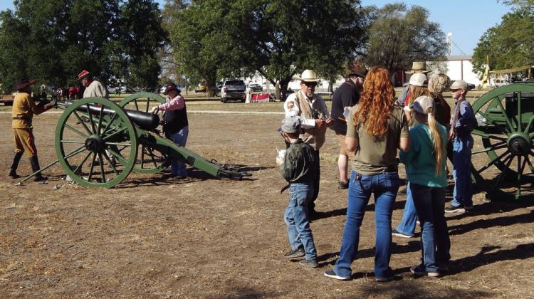 The Neeley Roughnecks Cannon Crew, assisted by Collingsworth County Sheriff Kent Riley and the Elliott family, of Childress, pack the powder and get ready to fire the cannon during the Friday morning, Oct. 4 Living History events at Powell Park.